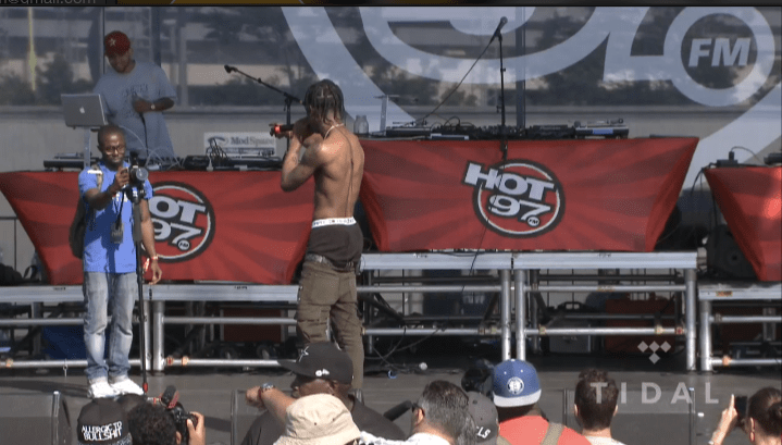 Travi$ Scott kicking a photographer off stage.